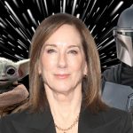 A cinematic shot featuring a Mandalorian, the small, green character Grogu, and Kathleen Kennedy.