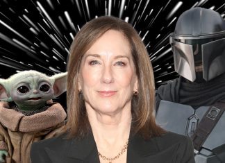 A cinematic shot featuring a Mandalorian, the small, green character Grogu, and Kathleen Kennedy.