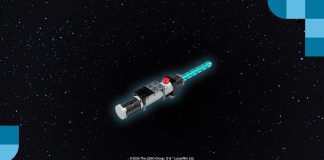 A brick-built LEGO Star Wars Lightsaber model with a glowing blue blade against a starry space background.