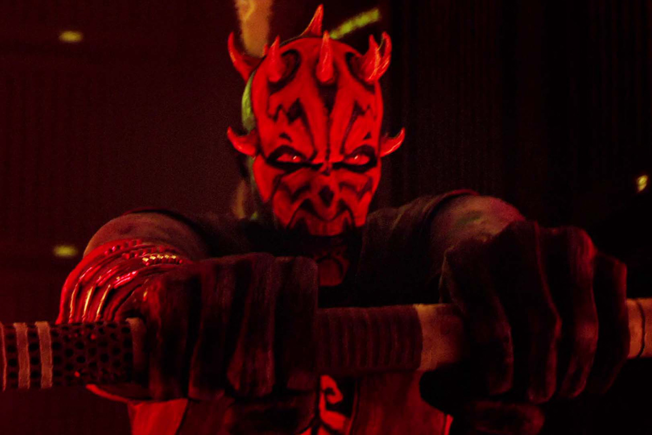 Close-up of Darth Maul with glowing red eyes, gripping a lightsaber hilt in a dark, atmospheric setting from the Star Wars: Maul Shadow Lord series.