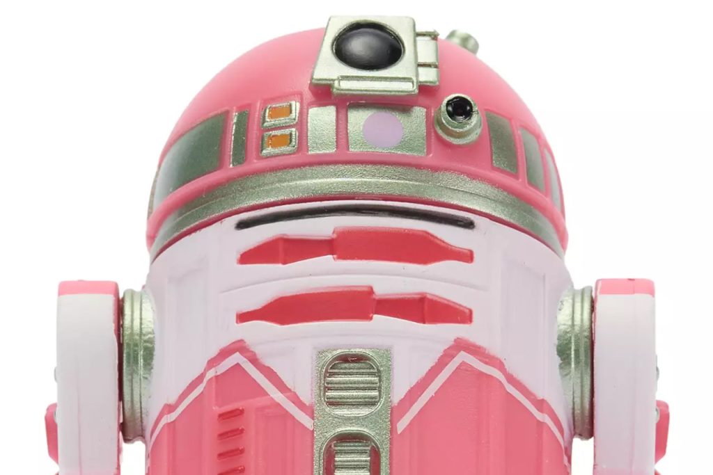 Close-up front view of the QT-KT Droid Factory action figure, featuring a vibrant pink and white dome with silver metallic accents and a black primary photoreceptor lens.
