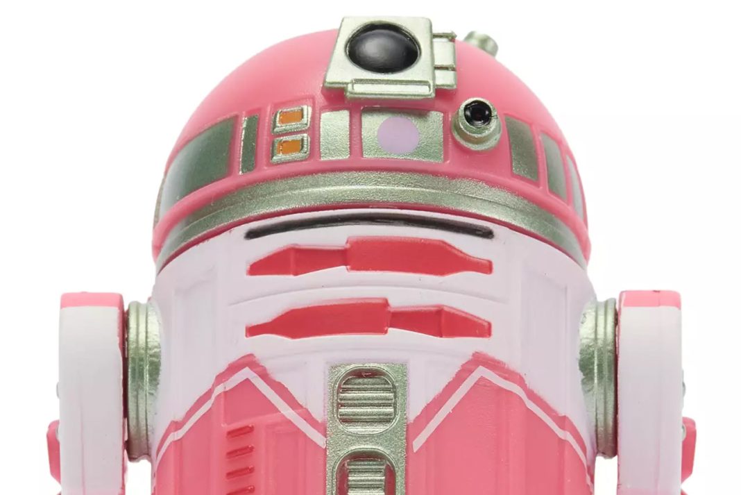 Close-up front view of the QT-KT Droid Factory action figure, featuring a vibrant pink and white dome with silver metallic accents and a black primary photoreceptor lens.