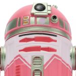 Close-up front view of the QT-KT Droid Factory action figure, featuring a vibrant pink and white dome with silver metallic accents and a black primary photoreceptor lens.