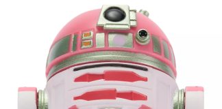 Close-up front view of the QT-KT Droid Factory action figure, featuring a vibrant pink and white dome with silver metallic accents and a black primary photoreceptor lens.