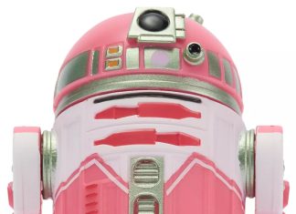 Close-up front view of the QT-KT Droid Factory action figure, featuring a vibrant pink and white dome with silver metallic accents and a black primary photoreceptor lens.