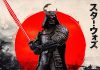 Close-up of the Iron Studios Darth Vader Samurai Statue 1/10 scale holding a red lightsaber katana against a red sun background.