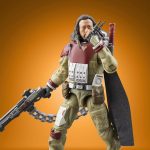 A detailed action figure of Baze Malbus from Star Wars Rogue One, part of The Vintage Collection, featuring his heavy repeating cannon and signature red and tan combat gear against an orange gradient background.
