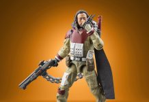 A detailed action figure of Baze Malbus from Star Wars Rogue One, part of The Vintage Collection, featuring his heavy repeating cannon and signature red and tan combat gear against an orange gradient background.