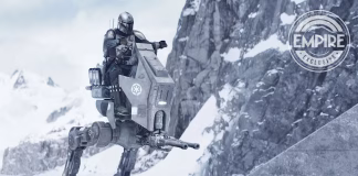 The Mandalorian (Din Djarin) piloting an Imperial AT-RT walker through a snowy, mountainous landscape in a still from The Mandalorian and Grogu movie.
