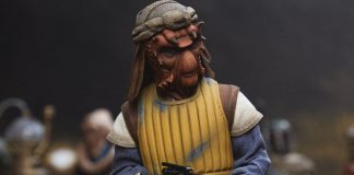 Sideshow Vizam Figure: The Ultimate Nikto Guard for Your Collection A high-detail sixth scale Sideshow Vizam figure wearing a yellow padded vest and holding a blaster pistol.