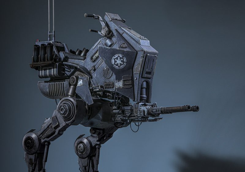 A side profile view of the Hot Toys 1/6th scale Imperial Remnant AT-RT walker featuring battle-worn weathering and an Imperial crest.