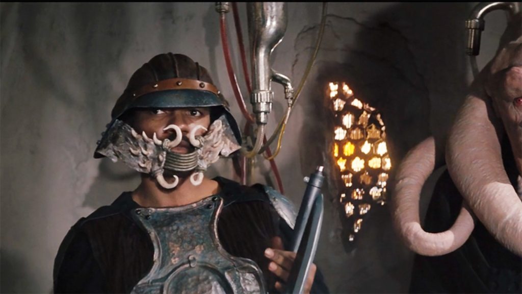 An image captured from Star Wars: Return of the Jedi featuring Lando Calrissian in his Skiff Guard outfit.