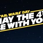 A wide graphic against a dark starry background featuring a bold yellow-bordered plaque with angled text. In smaller yellow text at the top it reads "STAR WARS DAY" and in large white block letters below it reads "MAY THE 4TH BE WITH YOU".