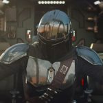 The Mandalorian and Grogu sitting in the cockpit of their starship, the Razor Crest, preparing for flight.