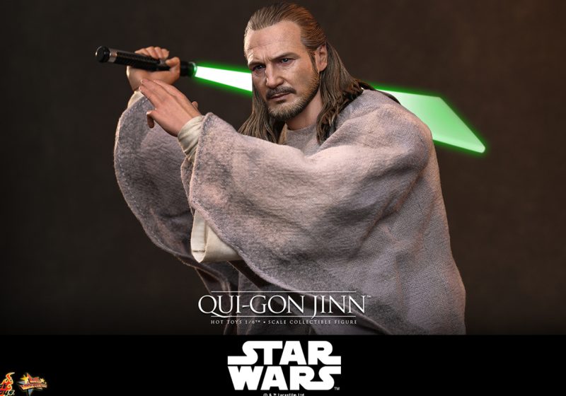 Hot Toys Qui-Gon Jinn 1/6th scale collectible figure wearing a gray poncho and wielding a green lightsaber.